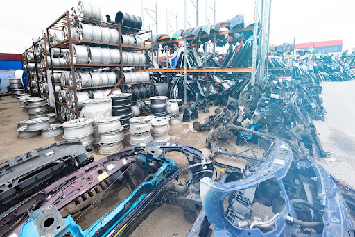 An organized display of car components in a used auto parts marketplace.