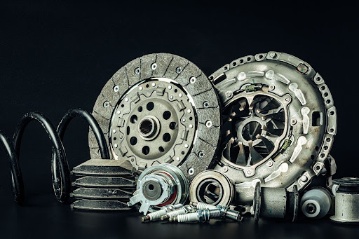 Detailed view of a used vehicle brake rotor on a dark surface.