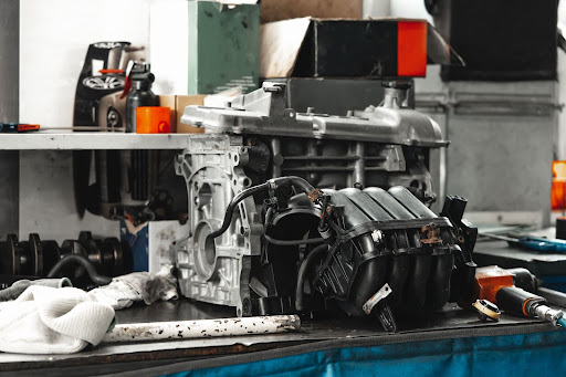 Engine components on a table in an auto service shop.