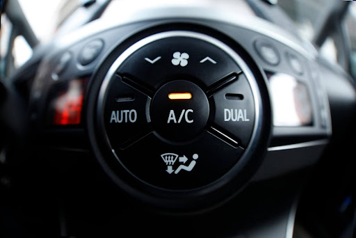 A close-up view of an air conditioning control knob set to cold.